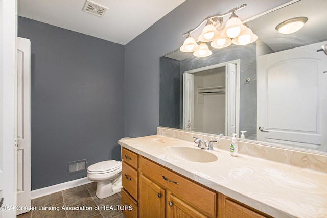 bathroom featuring toilet and vanity