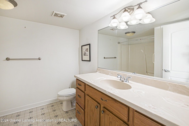 bathroom featuring a shower, toilet, and vanity