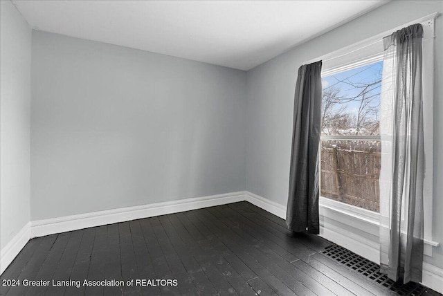 spare room featuring dark hardwood / wood-style floors