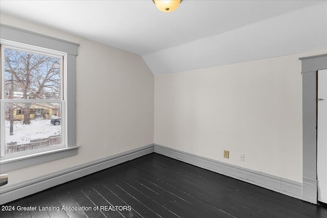 bonus room featuring vaulted ceiling, a baseboard heating unit, and dark hardwood / wood-style floors