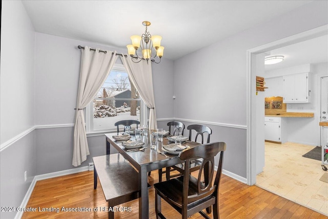 dining room with a chandelier and light wood-type flooring