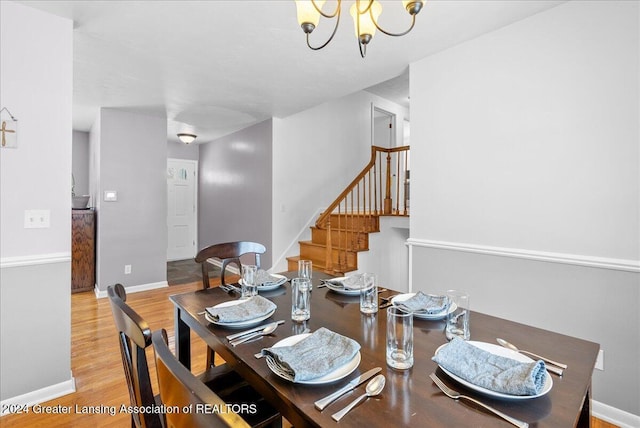 dining room featuring an inviting chandelier and light hardwood / wood-style floors