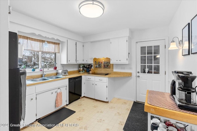 kitchen featuring white cabinetry, sink, and black appliances