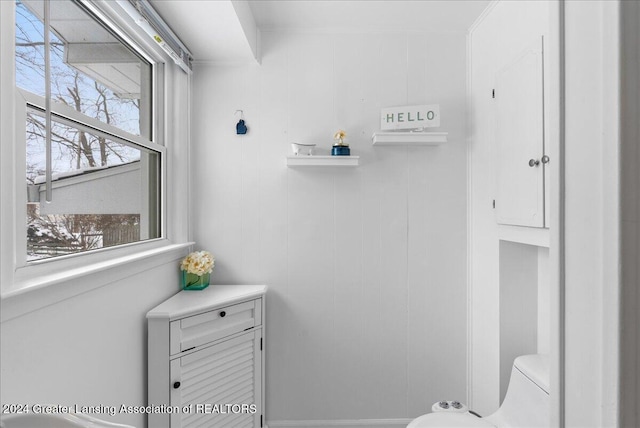 bathroom featuring a healthy amount of sunlight and toilet