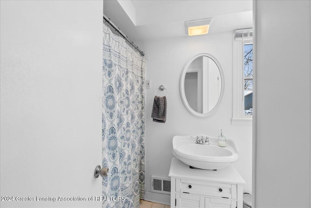 bathroom featuring vanity and a shower with shower curtain