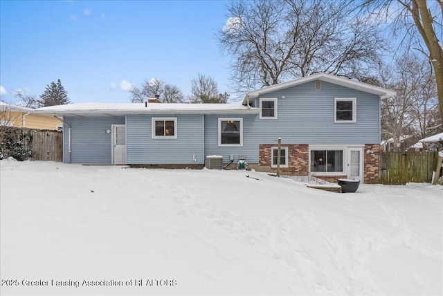 snow covered property featuring central air condition unit