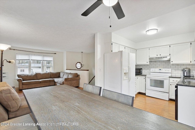 kitchen with white appliances, tasteful backsplash, white cabinetry, and light hardwood / wood-style floors