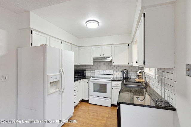 kitchen featuring white appliances, white cabinetry, sink, backsplash, and light wood-type flooring