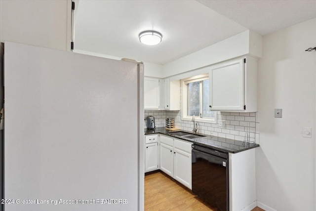 kitchen with sink, white refrigerator, light wood-type flooring, white cabinetry, and black dishwasher