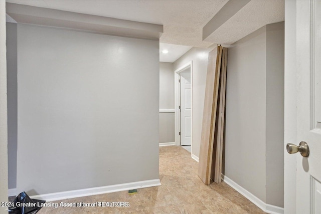 hallway with a textured ceiling