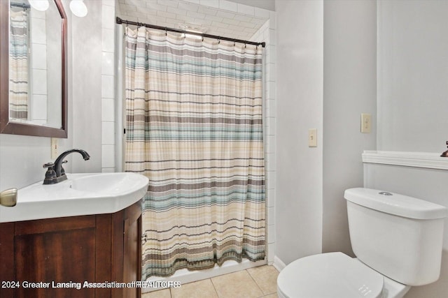 bathroom with vanity, toilet, a shower with shower curtain, and tile patterned flooring