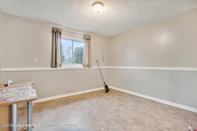 empty room with a textured ceiling