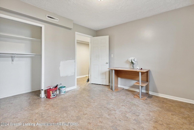 bedroom with a closet and a textured ceiling