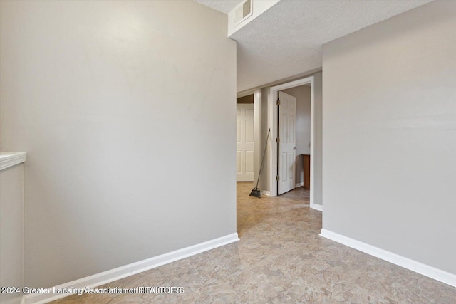 hallway featuring a textured ceiling