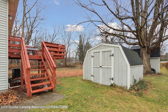 view of outbuilding featuring central AC unit and a yard