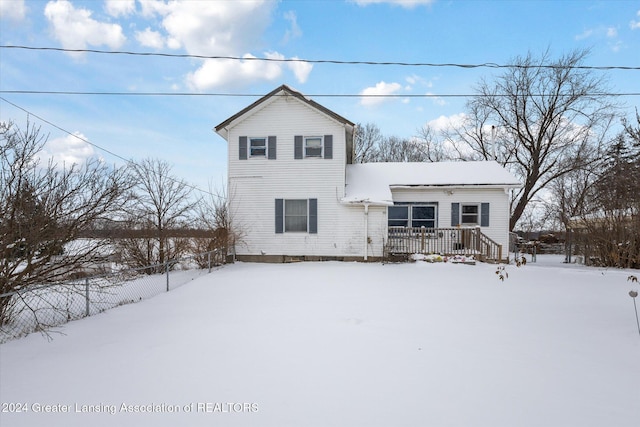 view of snow covered rear of property