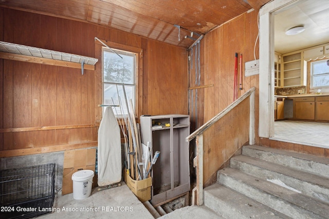 interior space featuring concrete flooring and wooden walls