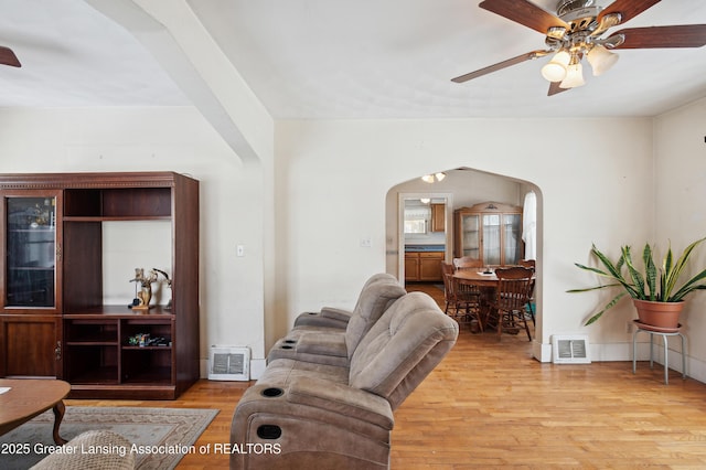 living room featuring ceiling fan and light hardwood / wood-style floors