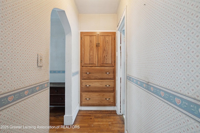 hallway with hardwood / wood-style flooring