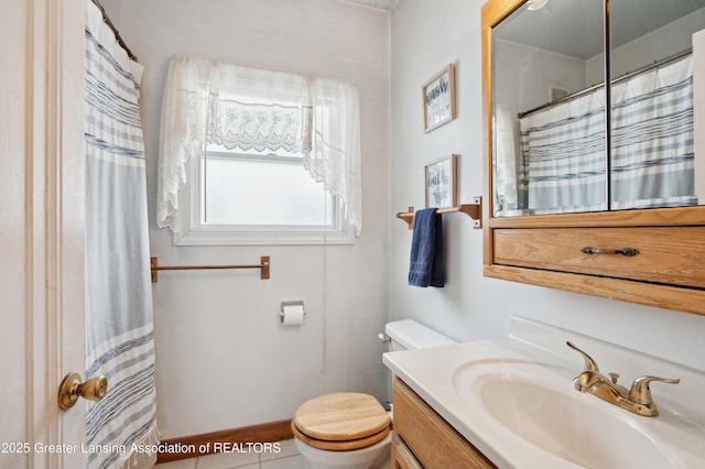 bathroom featuring tile patterned flooring, vanity, curtained shower, and toilet