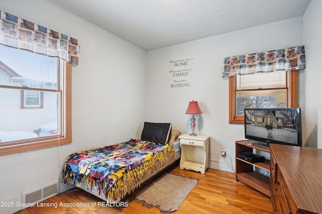 bedroom with hardwood / wood-style flooring