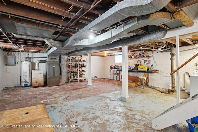 basement with water heater, heating unit, and electric panel