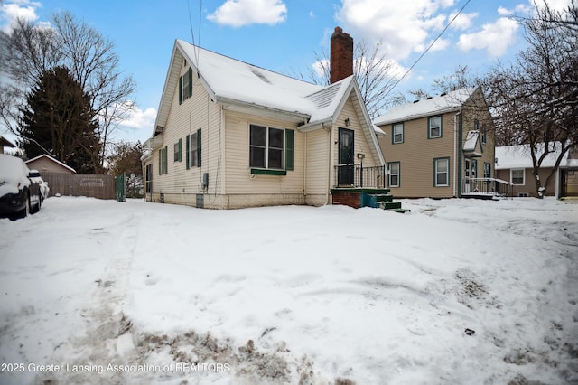 view of snow covered back of property