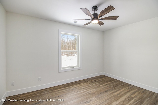 empty room featuring hardwood / wood-style flooring and ceiling fan