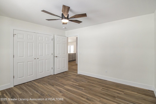 unfurnished bedroom with a closet, ceiling fan, and dark hardwood / wood-style flooring