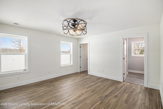 unfurnished room featuring dark hardwood / wood-style flooring