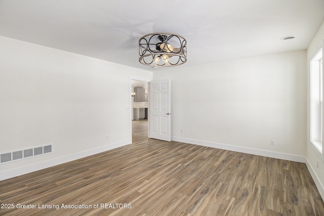 unfurnished room with dark hardwood / wood-style flooring