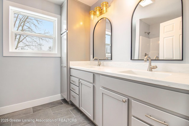 bathroom featuring vanity, a wealth of natural light, and walk in shower