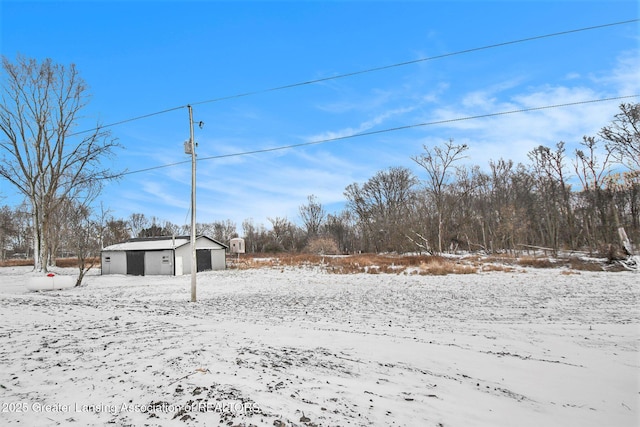 snowy yard with an outbuilding