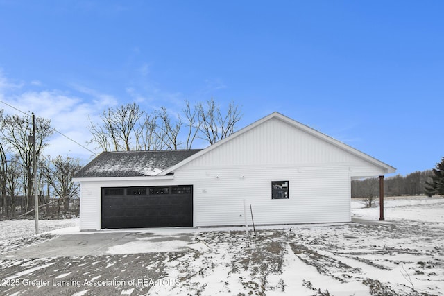 snow covered property featuring a garage