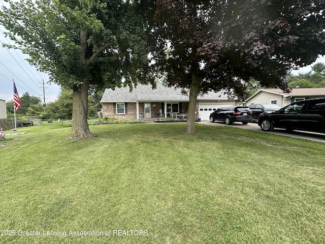 view of front of property with a garage and a front yard