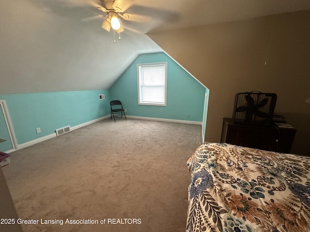 carpeted bedroom with vaulted ceiling and ceiling fan