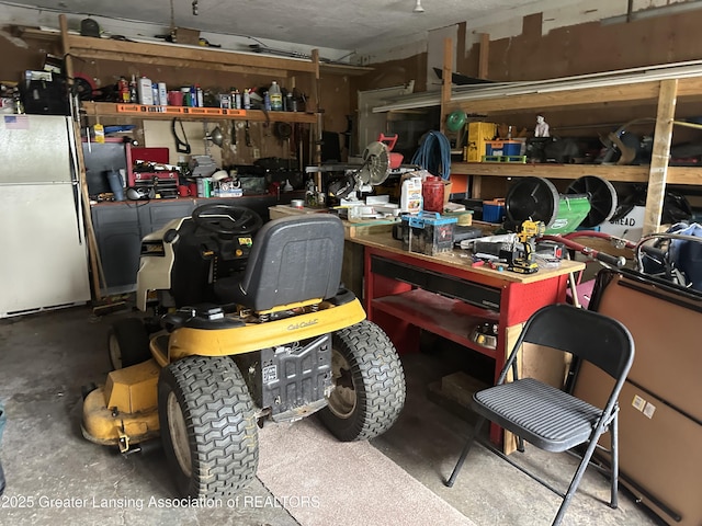 garage featuring fridge and a workshop area