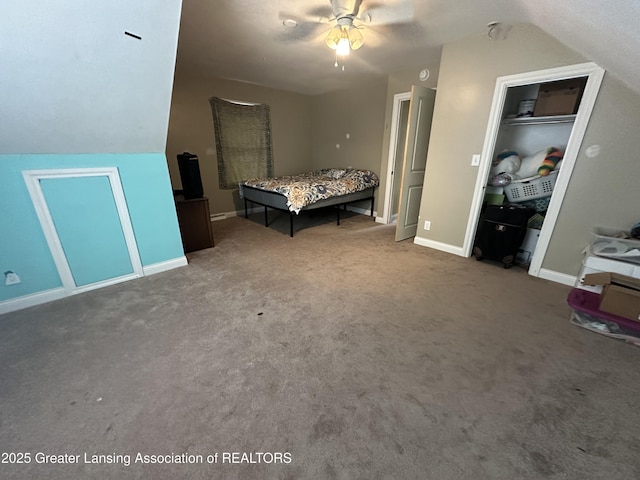 unfurnished bedroom with lofted ceiling, carpet floors, a closet, and ceiling fan