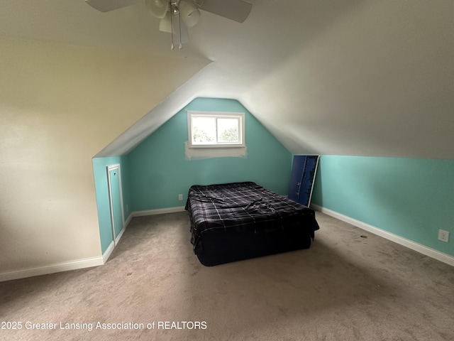 bedroom with ceiling fan, lofted ceiling, and light colored carpet