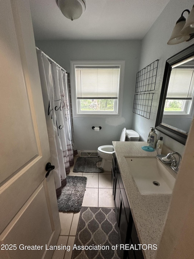 bathroom with tile patterned flooring, vanity, a shower with curtain, and toilet