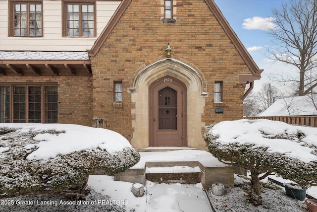 view of snow covered property entrance