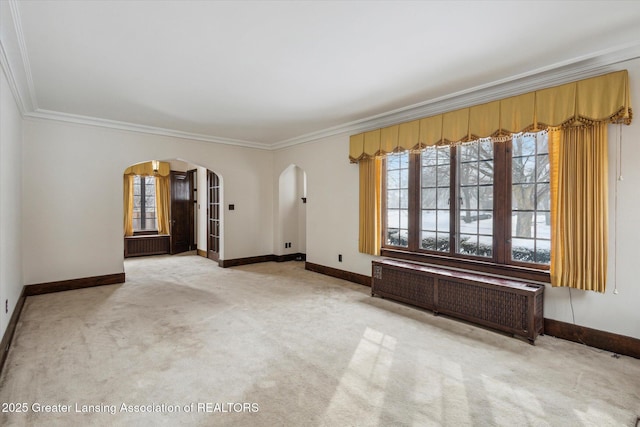 carpeted spare room with ornamental molding and radiator heating unit