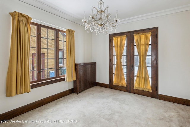 empty room with an inviting chandelier, crown molding, and carpet floors