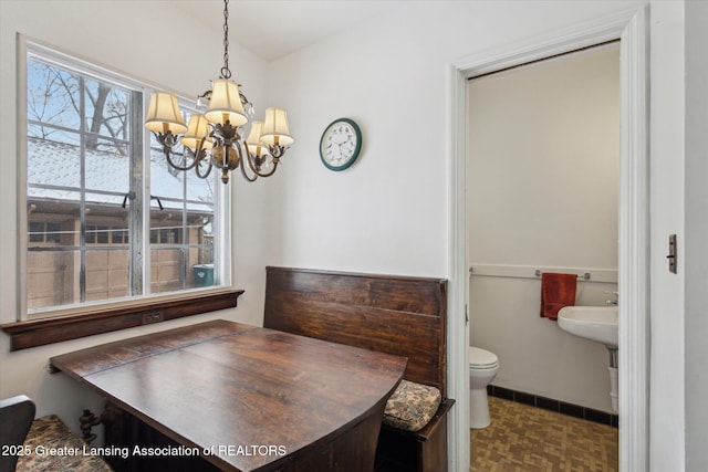 dining area featuring a notable chandelier