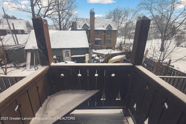 view of snow covered back of property