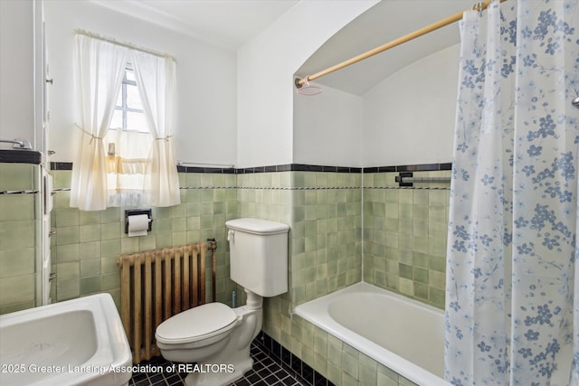 full bathroom featuring tile patterned floors, toilet, sink, tile walls, and radiator heating unit