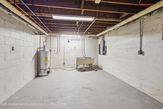 basement with sink, gas water heater, and electric panel