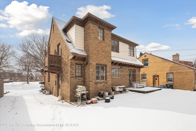 view of snow covered rear of property