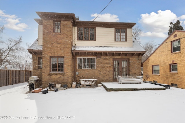 snow covered house with french doors