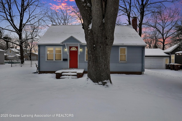 view of front of house featuring a garage and an outdoor structure